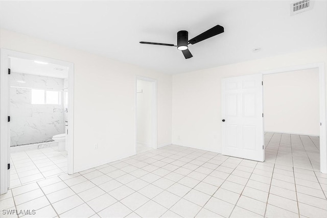 spare room with light tile patterned floors and ceiling fan