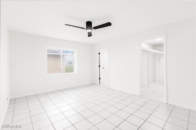 unfurnished bedroom with light tile patterned flooring and ceiling fan