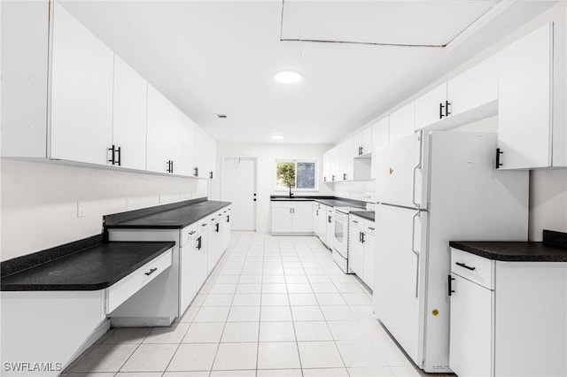 kitchen with white cabinetry, sink, light tile patterned floors, and white appliances