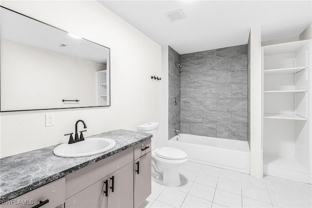 full bathroom featuring tile patterned flooring, vanity, tiled shower / bath, and toilet