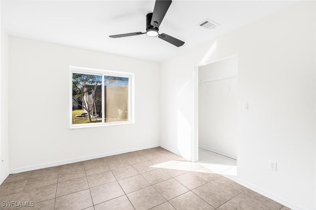 empty room with light tile patterned flooring and ceiling fan