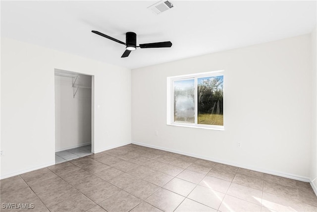 unfurnished bedroom featuring a closet, ceiling fan, and light tile patterned flooring