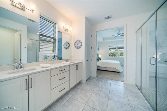 bathroom with ceiling fan, a shower with door, tile patterned floors, and vanity