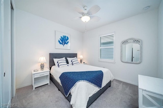 carpeted bedroom featuring ceiling fan and a closet