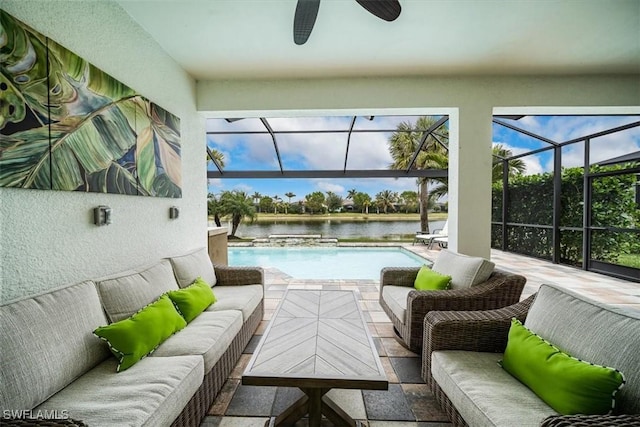 sunroom with a water view and ceiling fan