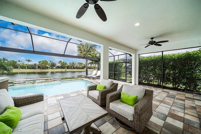 sunroom / solarium featuring ceiling fan, a water view, and plenty of natural light