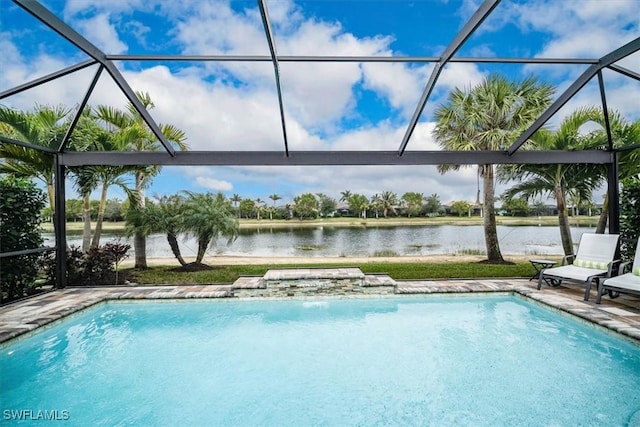 view of swimming pool with glass enclosure and a water view