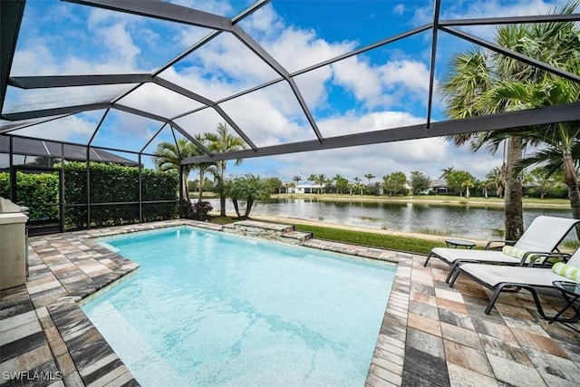 view of pool with a lanai, a patio area, and a water view