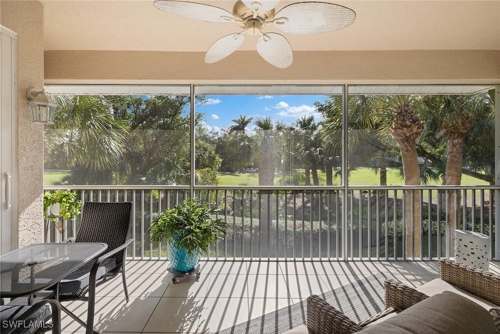 sunroom with ceiling fan and a wealth of natural light