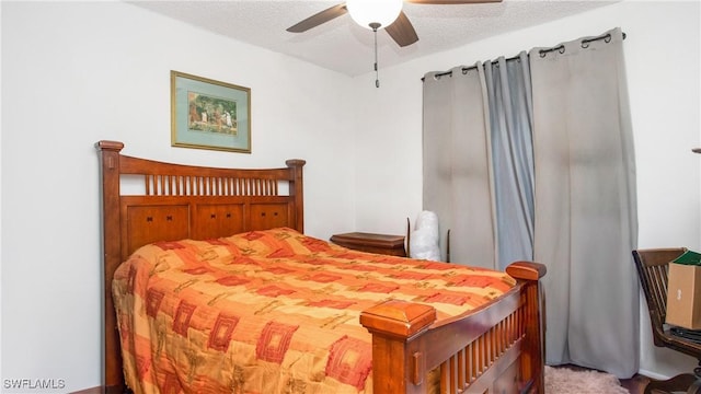 bedroom with ceiling fan and a textured ceiling