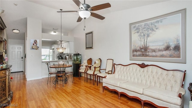 living room featuring light wood-type flooring, ceiling fan, and lofted ceiling