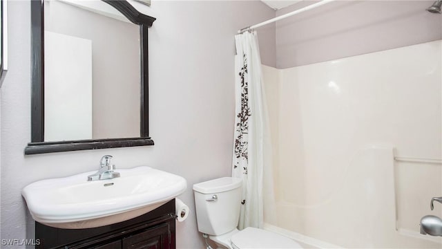 bathroom featuring toilet and vanity