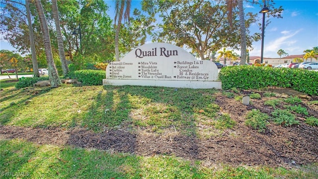 community sign featuring a lawn