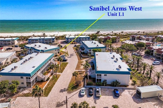 aerial view with a water view and a beach view