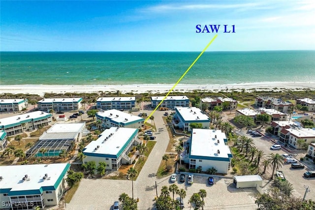 drone / aerial view with a water view and a view of the beach