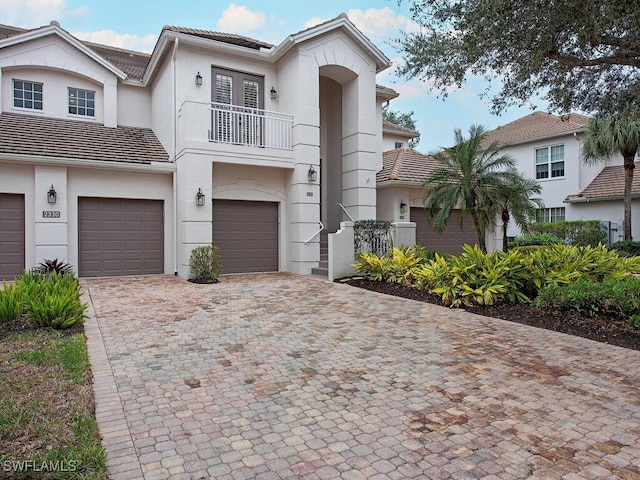 view of front of home featuring a garage and a balcony