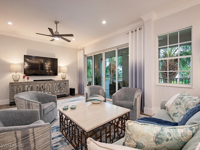 living room with crown molding, ceiling fan, light hardwood / wood-style flooring, and a wealth of natural light