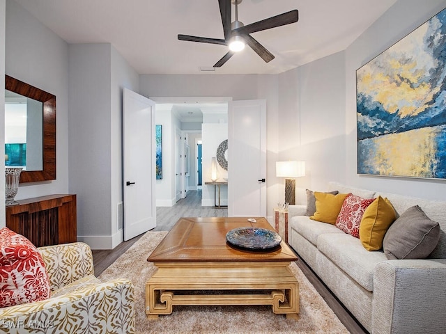 living room featuring ceiling fan and light wood-type flooring