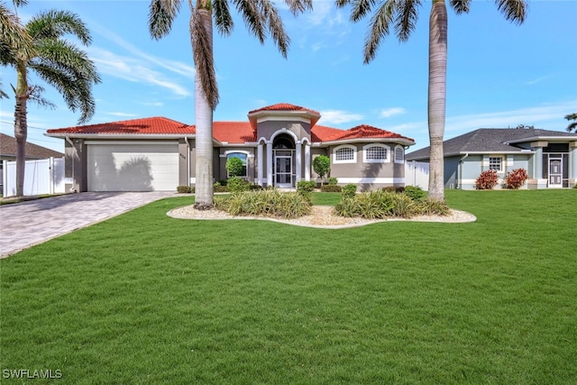 mediterranean / spanish-style home with a garage and a front yard