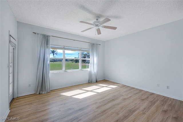 spare room with ceiling fan, light hardwood / wood-style flooring, and a textured ceiling