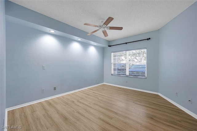 spare room featuring ceiling fan, a textured ceiling, and light wood-type flooring