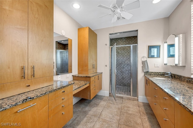 bathroom featuring ceiling fan, vanity, and an enclosed shower