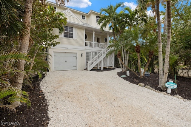 coastal home with a porch and a garage