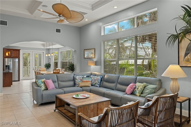 living room featuring coffered ceiling, beamed ceiling, and light tile patterned flooring