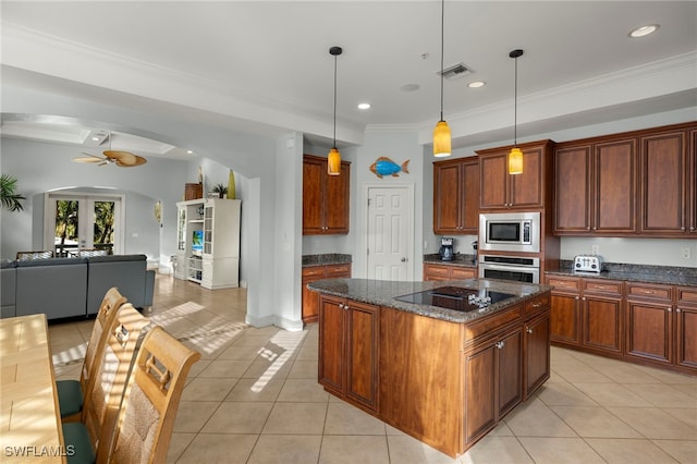 kitchen featuring hanging light fixtures, light tile patterned floors, dark stone countertops, a kitchen island, and stainless steel appliances