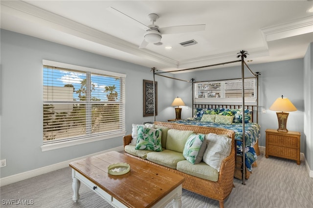 carpeted bedroom featuring ceiling fan, a raised ceiling, and crown molding