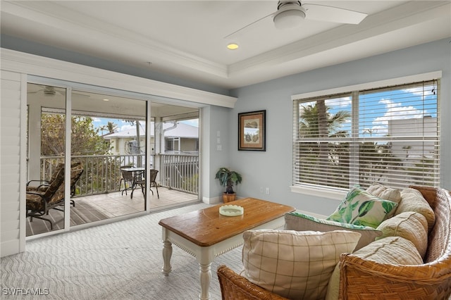 interior space featuring a tray ceiling and ceiling fan