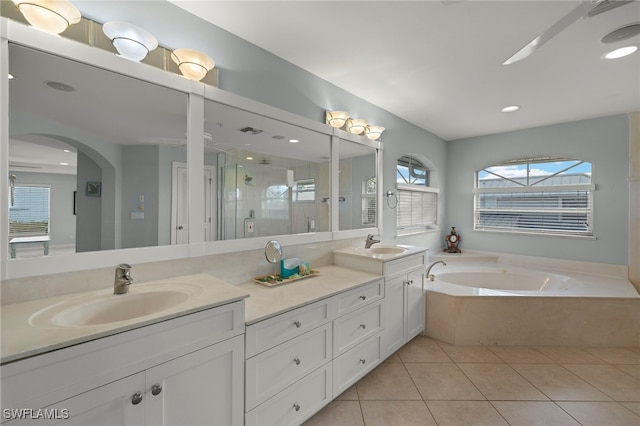 bathroom with vanity, tile patterned floors, and plus walk in shower