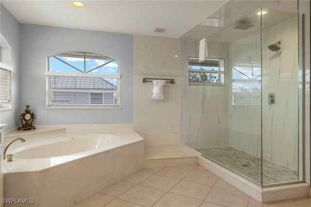 bathroom with tile patterned floors and separate shower and tub