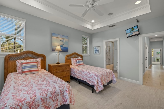 tiled bedroom with multiple windows, ensuite bath, ceiling fan, and a raised ceiling