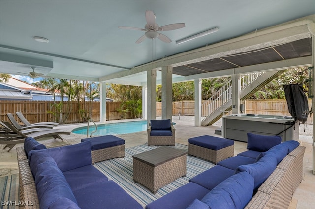 view of patio / terrace with ceiling fan, a swimming pool with hot tub, and outdoor lounge area