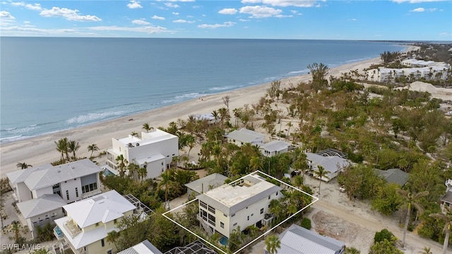 drone / aerial view with a water view and a view of the beach