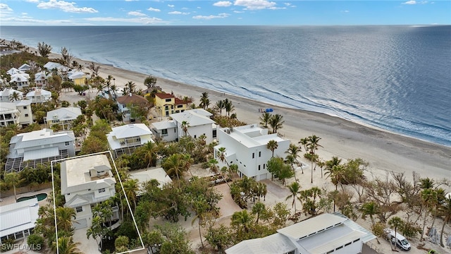 birds eye view of property featuring a water view and a beach view