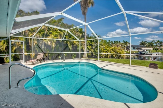 view of pool with a lanai, a water view, and a patio