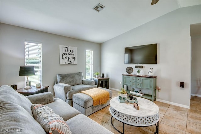 tiled living room with vaulted ceiling and plenty of natural light