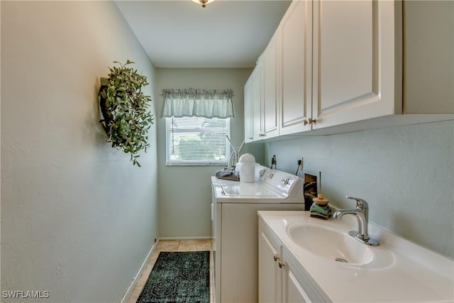 washroom featuring sink, separate washer and dryer, and light tile patterned flooring