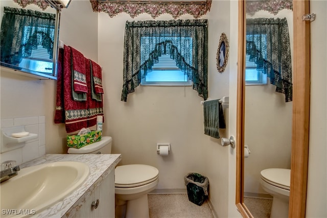 bathroom featuring toilet and vanity