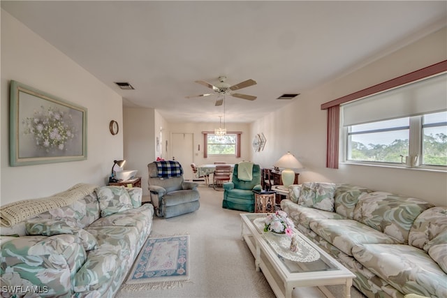 living room featuring carpet floors, ceiling fan, and plenty of natural light