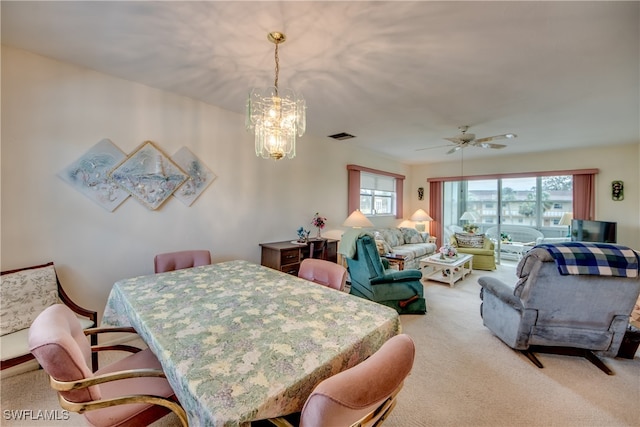 carpeted dining space with ceiling fan