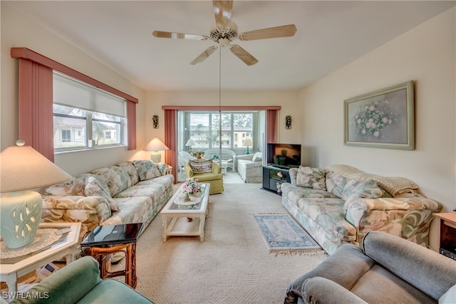 carpeted living room with ceiling fan