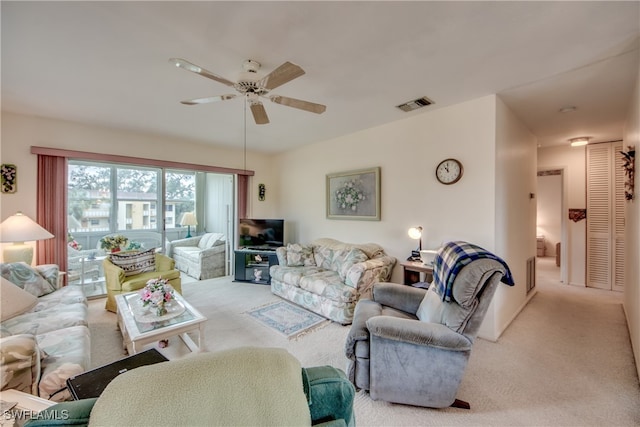 carpeted living room featuring ceiling fan