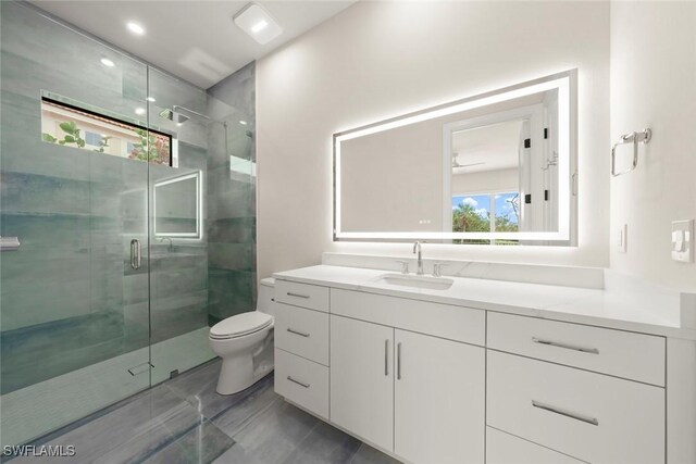 bathroom with vanity, toilet, and an enclosed shower