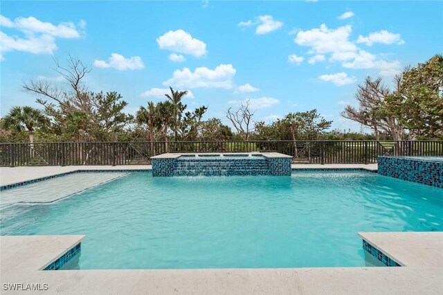 view of swimming pool with an in ground hot tub and pool water feature