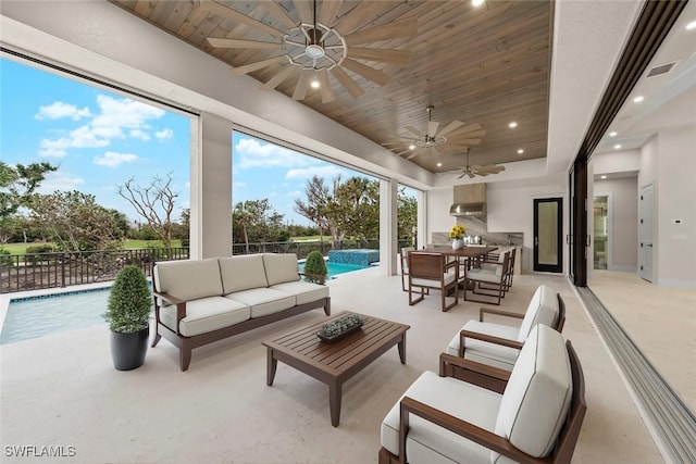 view of patio / terrace with an outdoor living space, a fenced in pool, and ceiling fan