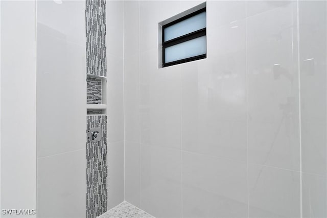 bathroom with tiled shower