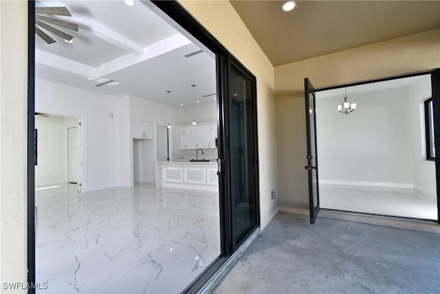 hall with a chandelier and sink